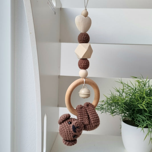 Ein handgefertigter Maxi-Cosi-Anhänger aus bunten Perlen, Häkeltier und Holzelementen, der unterwegs für Unterhaltung sorgt. Die verschiedenen Farben und Texturen machen das Reisen mit dem Baby nie langweilig. Ideal für Maxi-Cosi, Kinderwagen oder Bettchen.