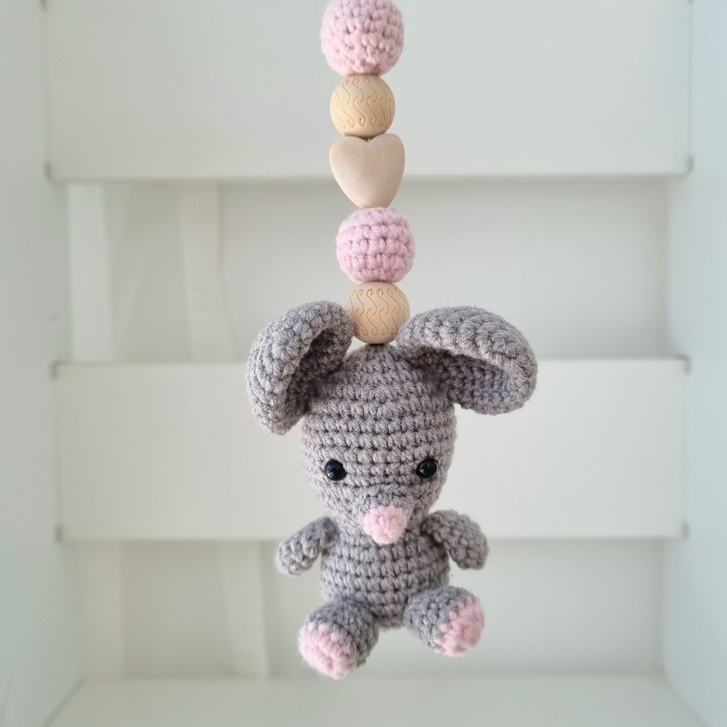 Ein handgefertigter Maxi-Cosi-Anhänger aus bunten Perlen, Häkeltier und Holzelementen, der unterwegs für Unterhaltung sorgt. Die verschiedenen Farben und Texturen machen das Reisen mit dem Baby nie langweilig. Ideal für Maxi-Cosi, Kinderwagen oder Bettchen.