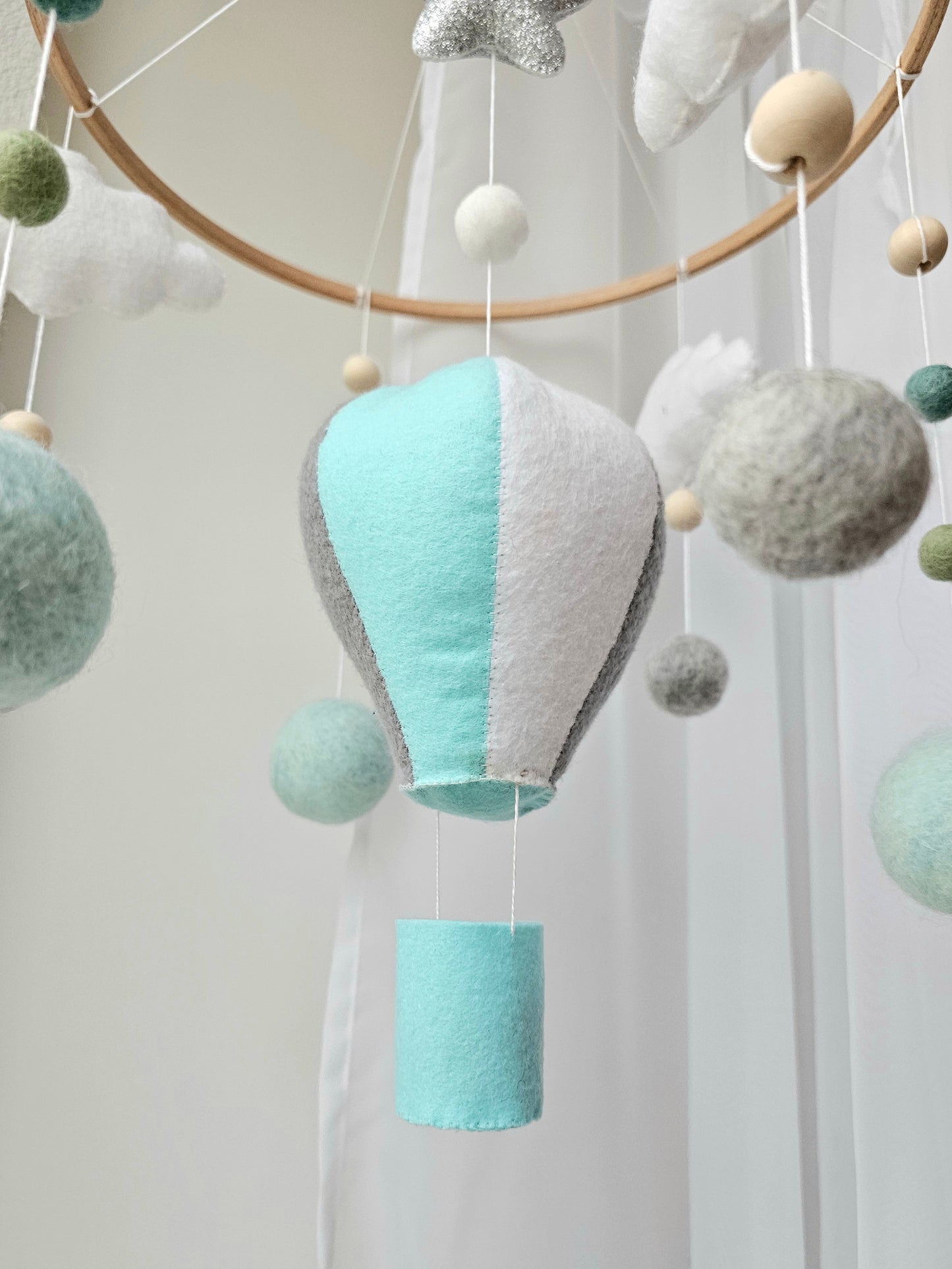 Selbstgemachtes Babymobile mit liebevoll handgefertigten Figuren und Formen, ideal für das Kinderbett oder den Kinderwagen. Hergestellt aus weichem, hochwertigem Filz in bunten Farben, fördert das Babymobile die visuelle und sensorische Entwicklung des Babys. Leicht und sicher aufzuhängen, schafft es eine beruhigende und kreative Umgebung für Ihr Kind.