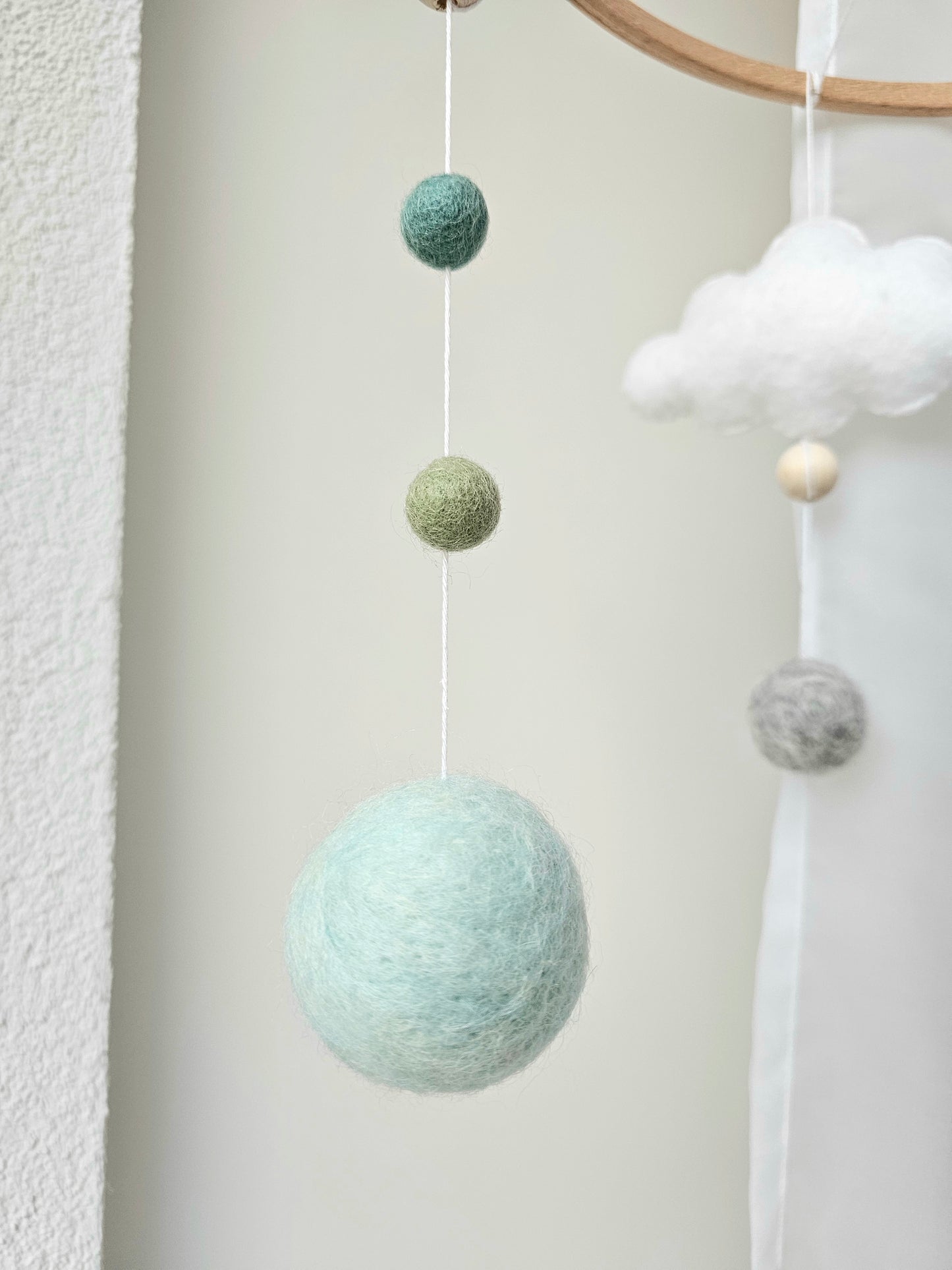 Selbstgemachtes Babymobile mit liebevoll handgefertigten Figuren und Formen, ideal für das Kinderbett oder den Kinderwagen. Hergestellt aus weichem, hochwertigem Filz in bunten Farben, fördert das Babymobile die visuelle und sensorische Entwicklung des Babys. Leicht und sicher aufzuhängen, schafft es eine beruhigende und kreative Umgebung für Ihr Kind.