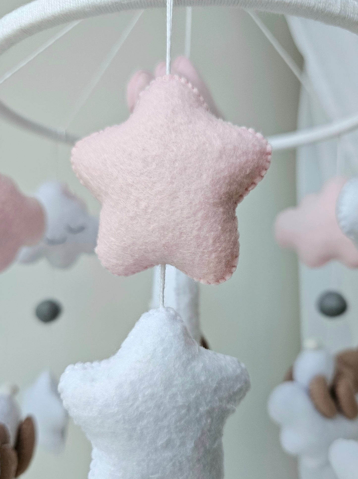 Selbstgemachtes Babymobile mit liebevoll handgefertigten Figuren und Formen, ideal für das Kinderbett oder den Kinderwagen. Hergestellt aus weichem, hochwertigem Filz in bunten Farben, fördert das Babymobile die visuelle und sensorische Entwicklung des Babys. Leicht und sicher aufzuhängen, schafft es eine beruhigende und kreative Umgebung für Ihr Kind.