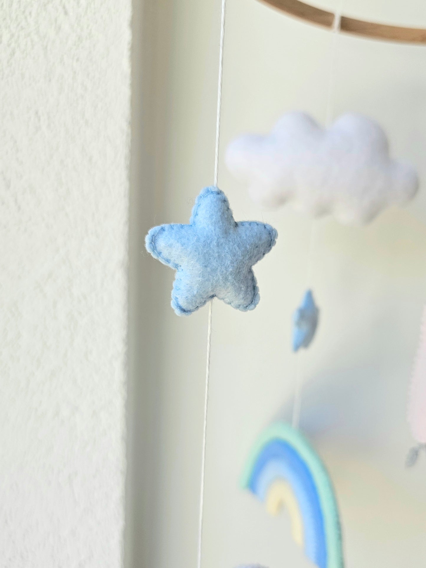 Selbstgemachtes Babymobile mit liebevoll handgefertigten Figuren und Formen, ideal für das Kinderbett oder den Kinderwagen. Hergestellt aus weichem, hochwertigem Filz in bunten Farben, fördert das Babymobile die visuelle und sensorische Entwicklung des Babys. Leicht und sicher aufzuhängen, schafft es eine beruhigende und kreative Umgebung für Ihr Kind.